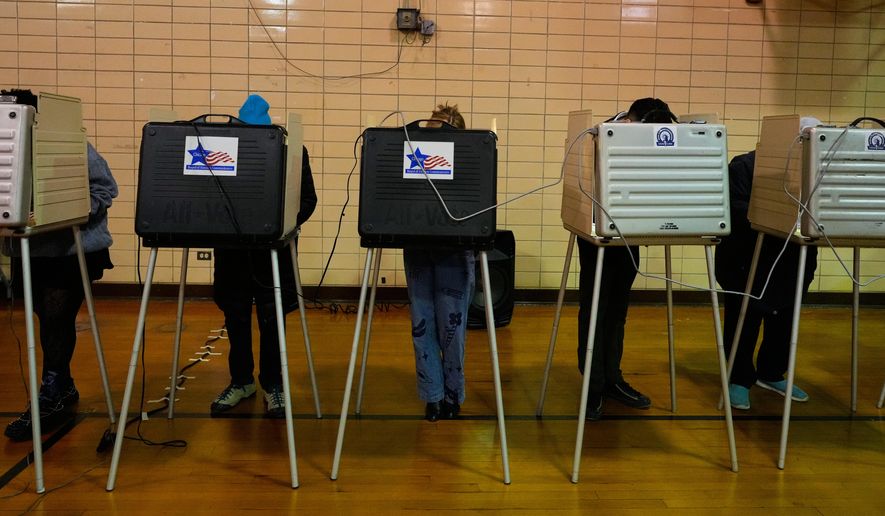 Democratic candidate for Congress, Kat Abughazaleh, center, casts her vote in a primary election for the upcoming midterms, in Chicago, Tuesday, March 17, 2026. (AP Photo/Nam Y. Huh)