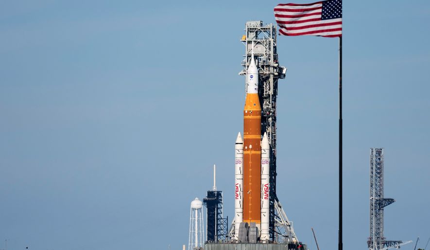 FILE - NASA's Artemis II SLS (Space Launch System) moon rocket with the Orion spacecraft slowly rolls back towards the Vehicle Assembly Building at the Kennedy Space Center, Feb. 25, 2026, in Cape Canaveral, Fla. (AP Photo/John Raoux, File
