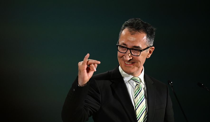 Cem Özdemir (Alliance 90/The Greens), top candidate in the Baden-Württemberg state elections, makes a gesture at his party's election party and stretches up the little finger of his right hand, in Stuttgart, Germany, Sunday, March 8, 2026. (Bernd Weißbrod/dpa via AP)