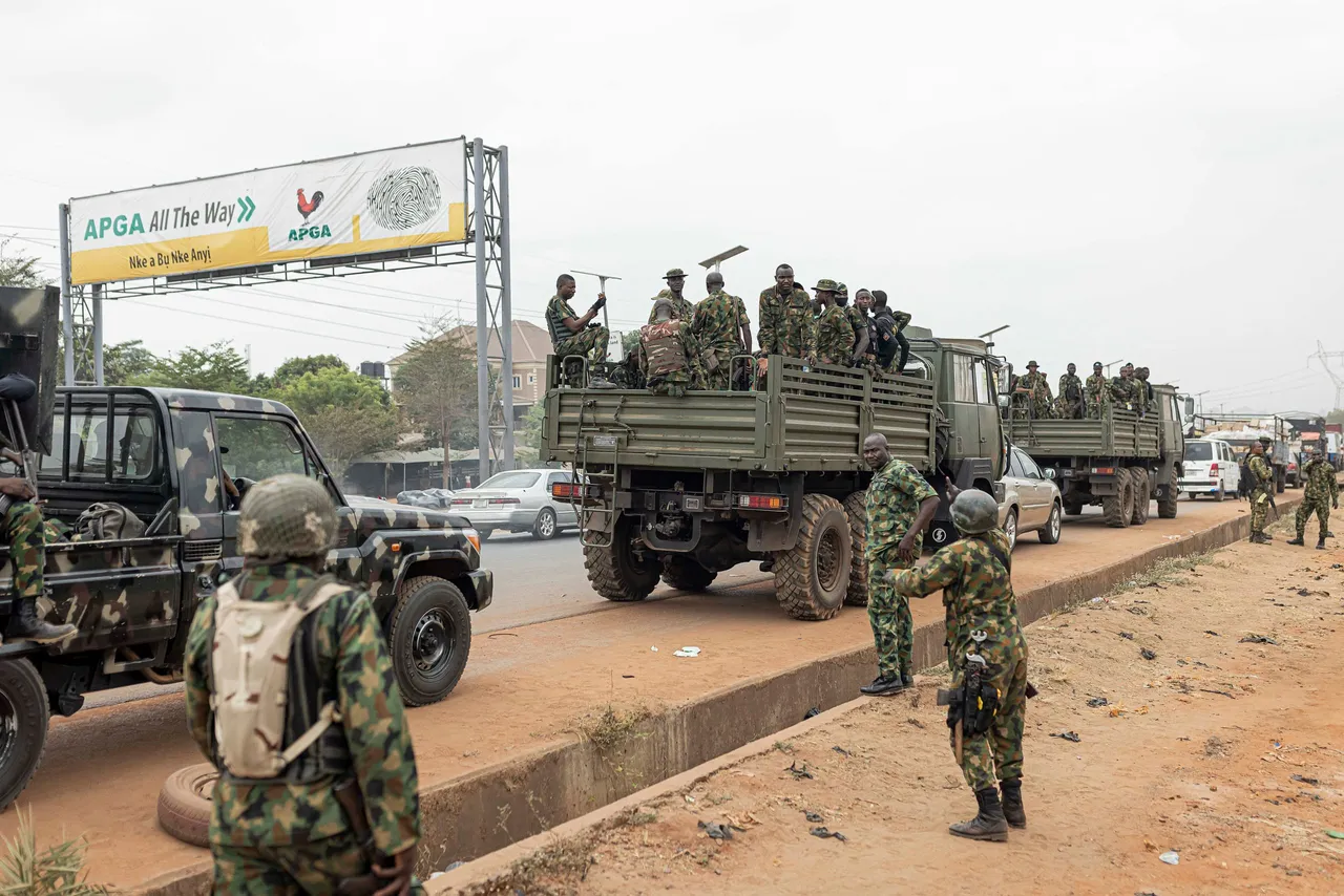 TOPSHOT - Armed Nigerian army officers stand inside military vehicles parked outside the Central Bank of Nigeria (CBN) in Awka, Nigeria, on February 24, 2023, ahead of the Nigerian presidential elections scheduled for February 25, 2023. (Photo by PATRICK MEINHARDT/AFP via Getty Images)