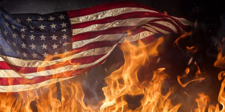 Radical Anti-ICE Extremist Accidentally Sets Himself on Fire While Burning American Flag [WATCH]