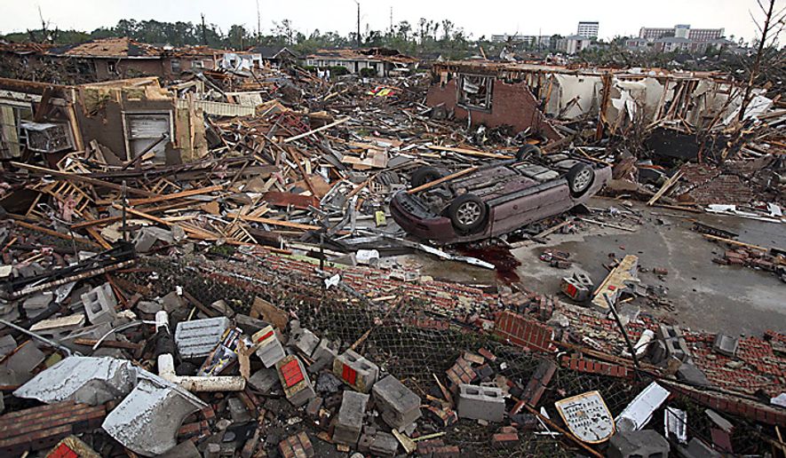 A car lies overturns and buildings destroyed in Tuscaloosa, Ala., Wednesday, April 27, 2011. A wave of severe storms laced with tornadoes strafed the South on Wednesday; buildings across swaths of the university town were damaged or destroyed. (AP Photo/Tuscaloosa News, Dusty Compton)