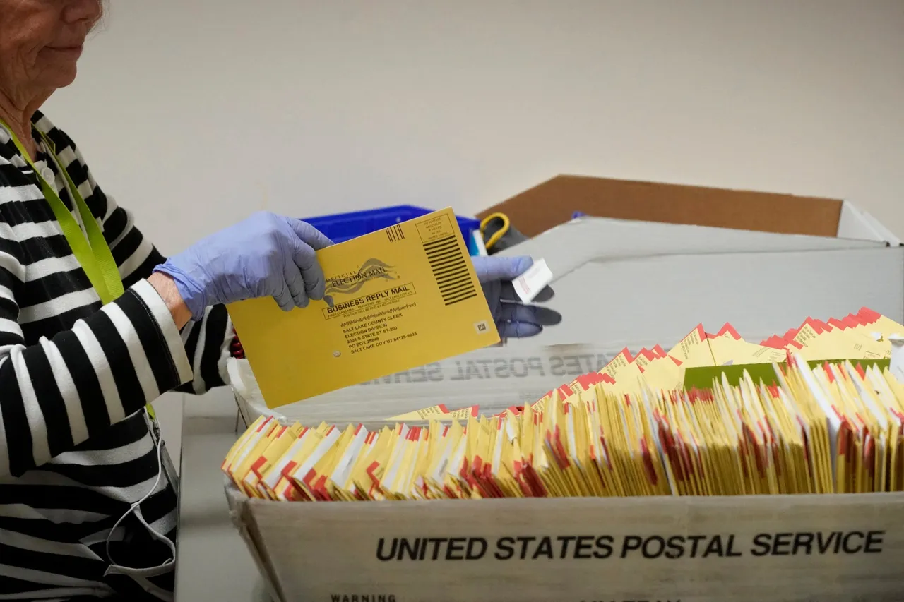 An election worker processes a container of mail-in ballots from the postal service to be processed at the Salt Lake County election offices in Salt Lake City, Utah, on November 4, 2024.