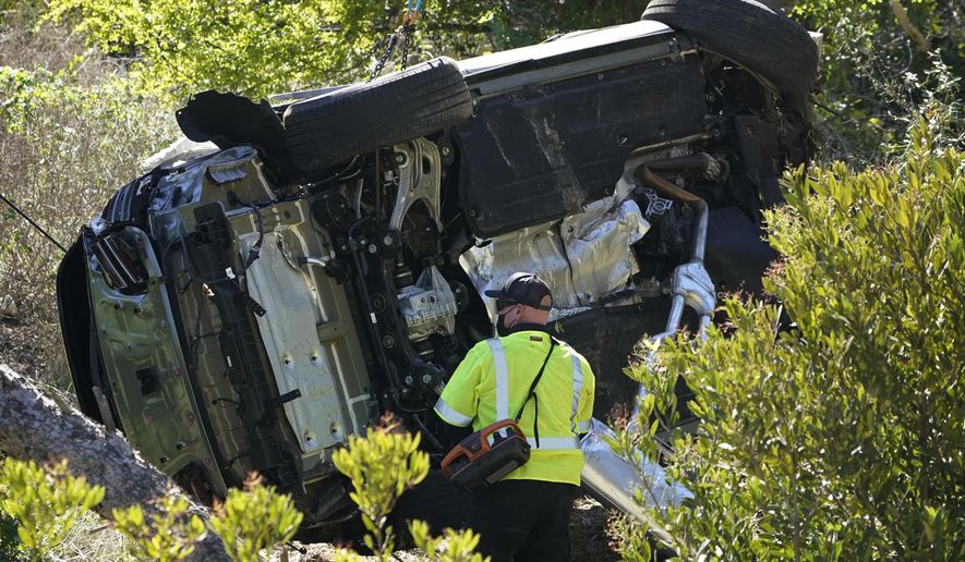FILE - In this Feb. 23, 2021, file photo a vehicle rests on its side after a rollover accident involving golfer Tiger Woods, in Rancho Palos Verdes, Calif., a suburb of Los Angeles. The Los Angeles County sheriff says detectives have determined what caused Tiger Woods to crash his SUV last month in Southern California but would not release details on Wednesday, March 31, 2021, citing privacy concerns for the golf star. (AP Photo/Marcio Jose Sanchez, File)