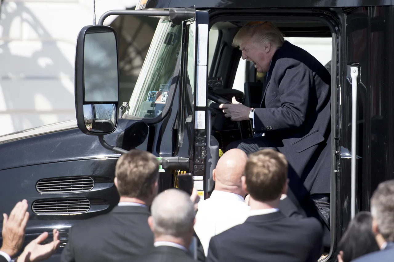 President Donald Trump sits in the drivers seat of a semi-truck as he welcomes truckers and CEOs to the White House in Washington, DC, March 23, 2017