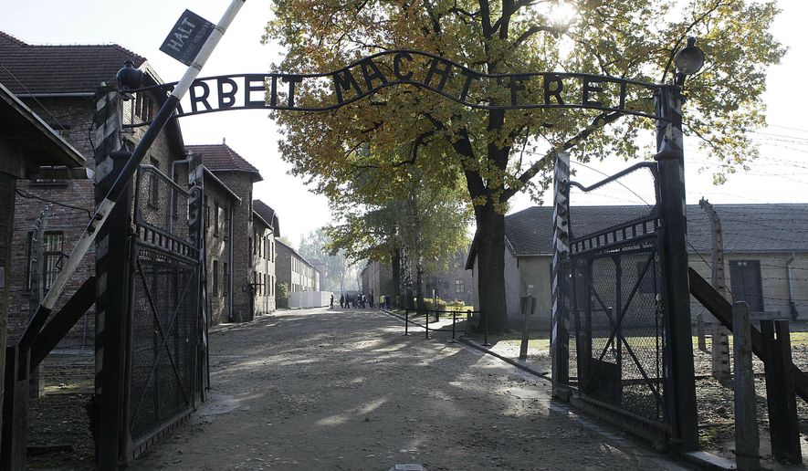This Friday, Oct. 19, 2012, file photo shows the entrance to the former Nazi German Auschwitz death camp with the inscription "Arbeit Macht Frei" (Work Sets You Free) in Oswiecim, Poland. AP Photo/Czarek Sokolowski, file)